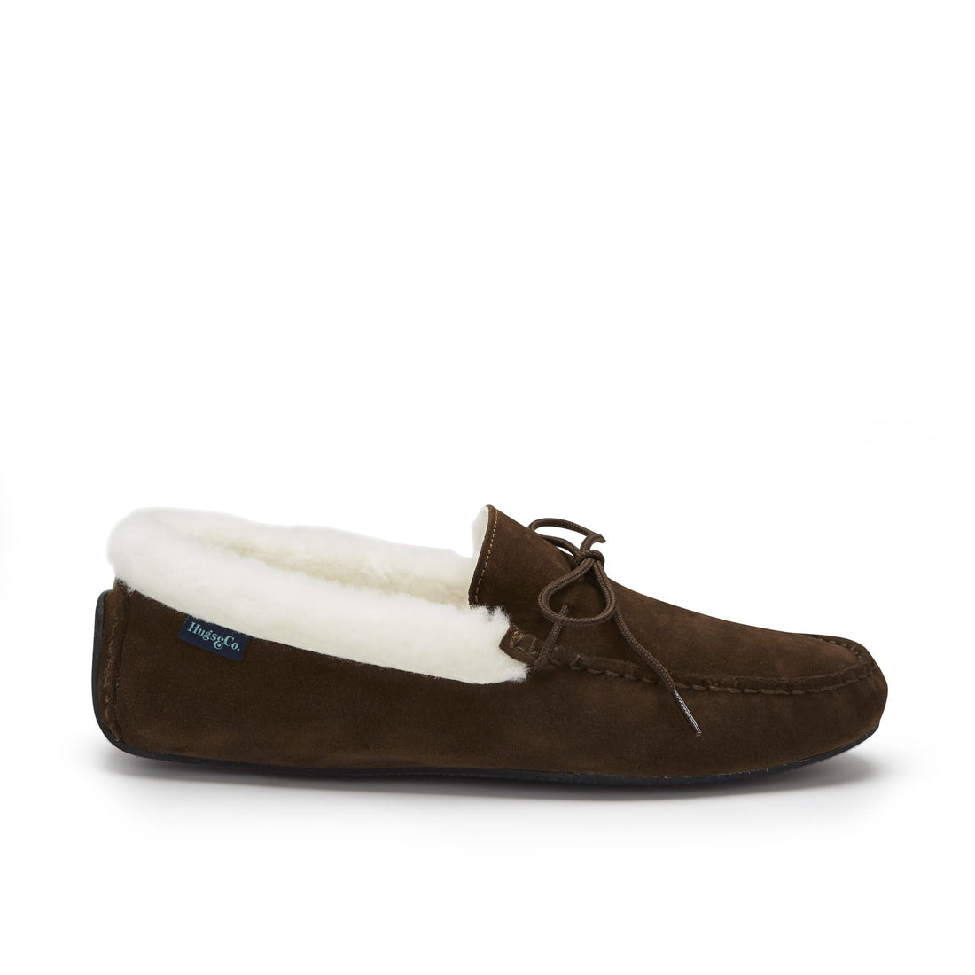 Brown suede sheepskin slipper with cream lining, moc toe stitching, and lace-up detail