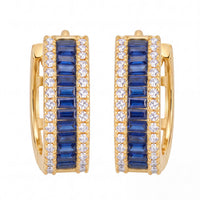 Gold huggie hoop earrings with sapphire blue baguette stones and clear pavé accents