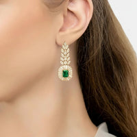 Emerald gold drop earrings with leaf detail and green gemstone