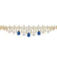 Gold tennis bracelet with pear-shaped sapphire and clear stone drops