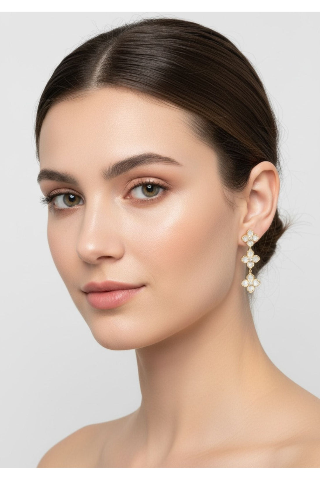 Mother-of-pearl clover triple-drop earrings in gold, worn near the ear