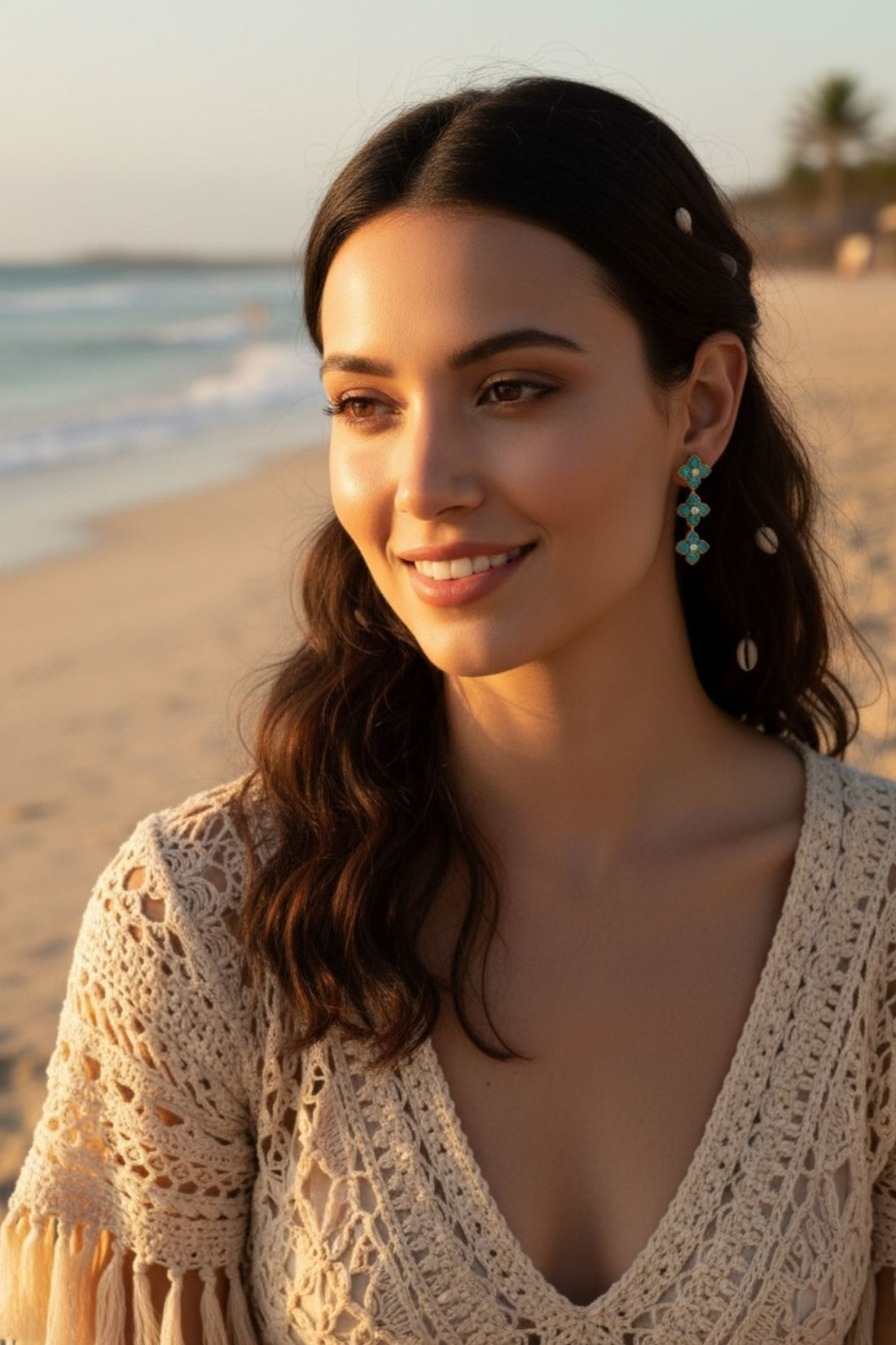 Turquoise flower drop earrings with crystal centers on gold-tone, side view