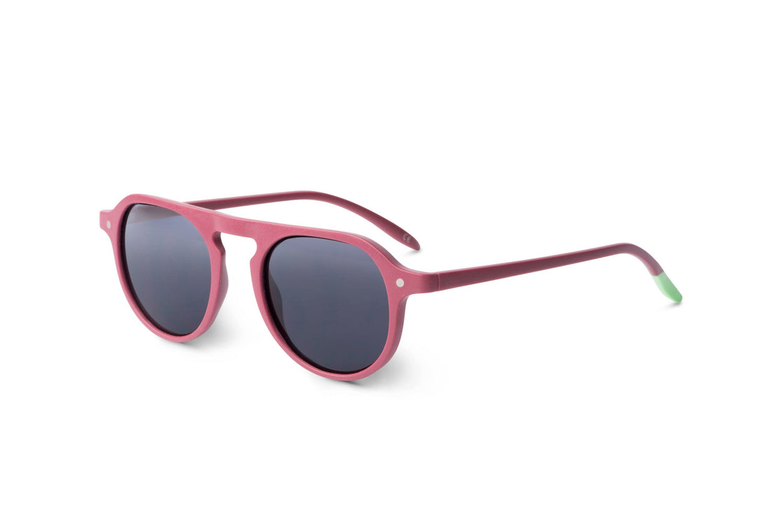 Raspberry pink rounded sunglasses with dark lenses, side view