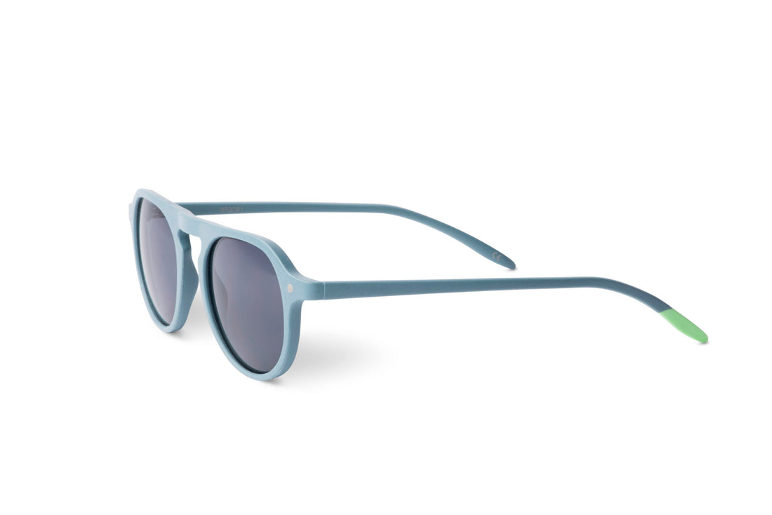 Steel blue sunglasses side profile with dark round lenses and green temple tips