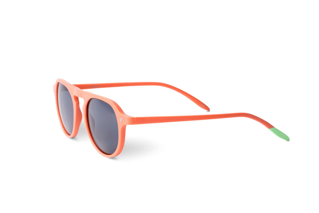 Tangerine cat-eye sunglasses with dark lenses, temple and green tip