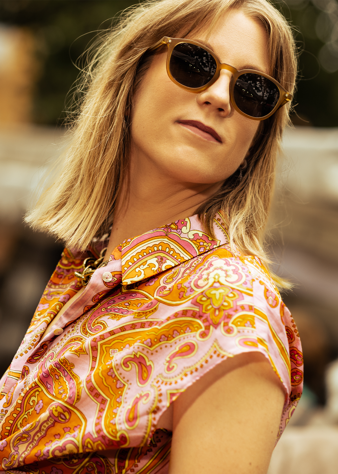 Round bamboo sunglasses with dark lenses on a woman