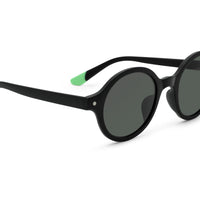 Black round sunglasses, side view with green temple accent and dark lenses