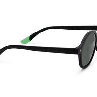 Black round sunglasses profile view with green temple tip and dark lenses