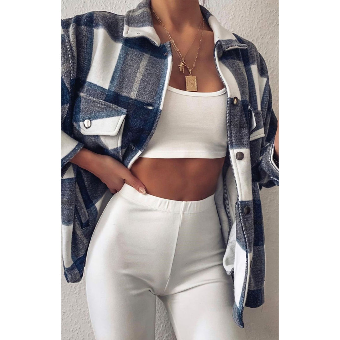 White elastic-waist pants with blue plaid shirt open front.