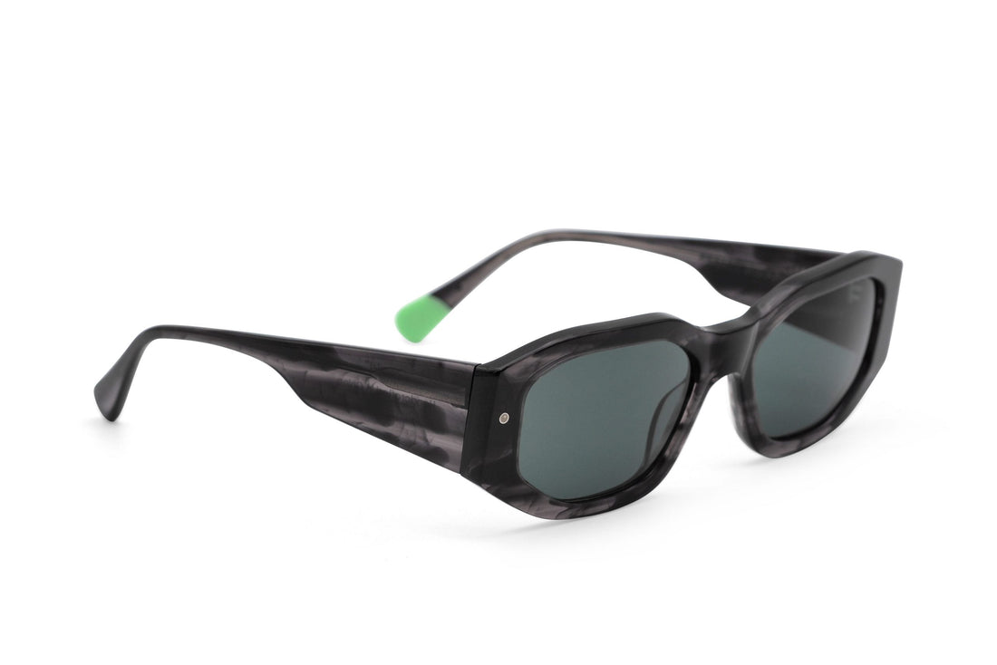 Tayrona smokey black sunglasses, angled view, dark tortoiseshell frame and green lenses