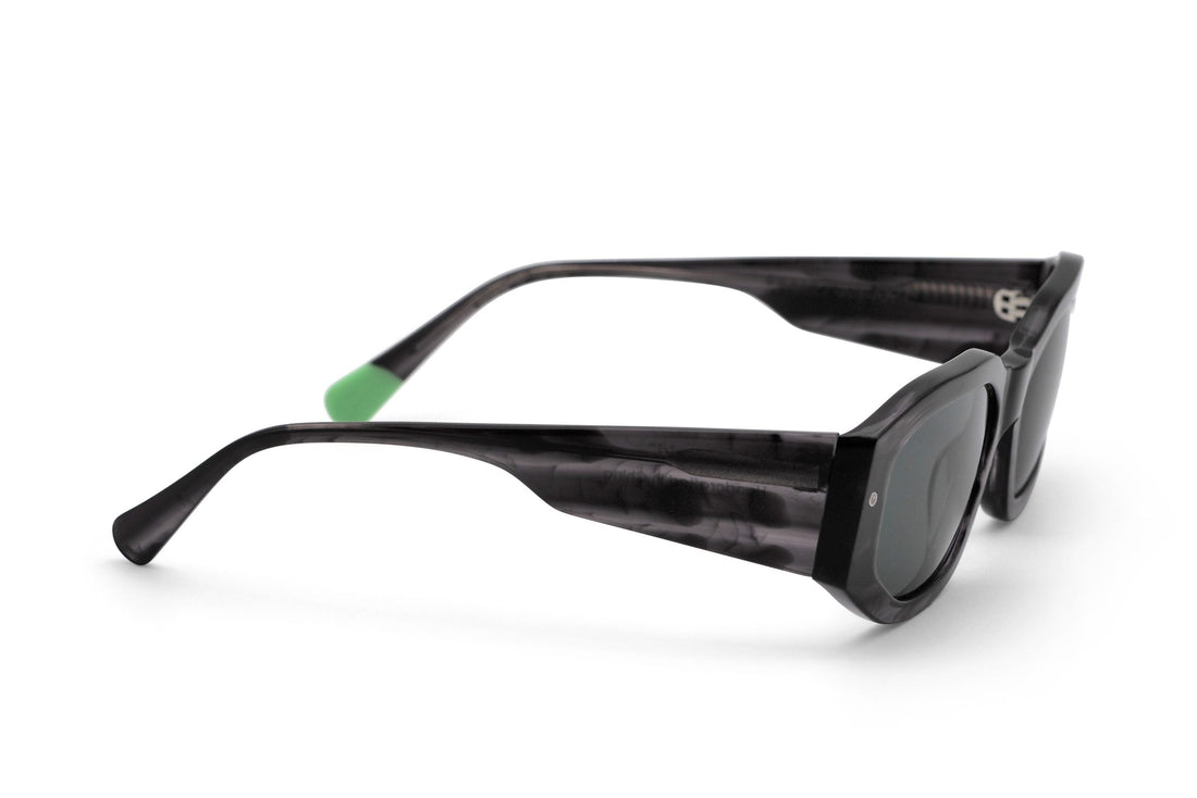 Tayrona smokey black sunglasses, side view with green tinted lenses and dark frame