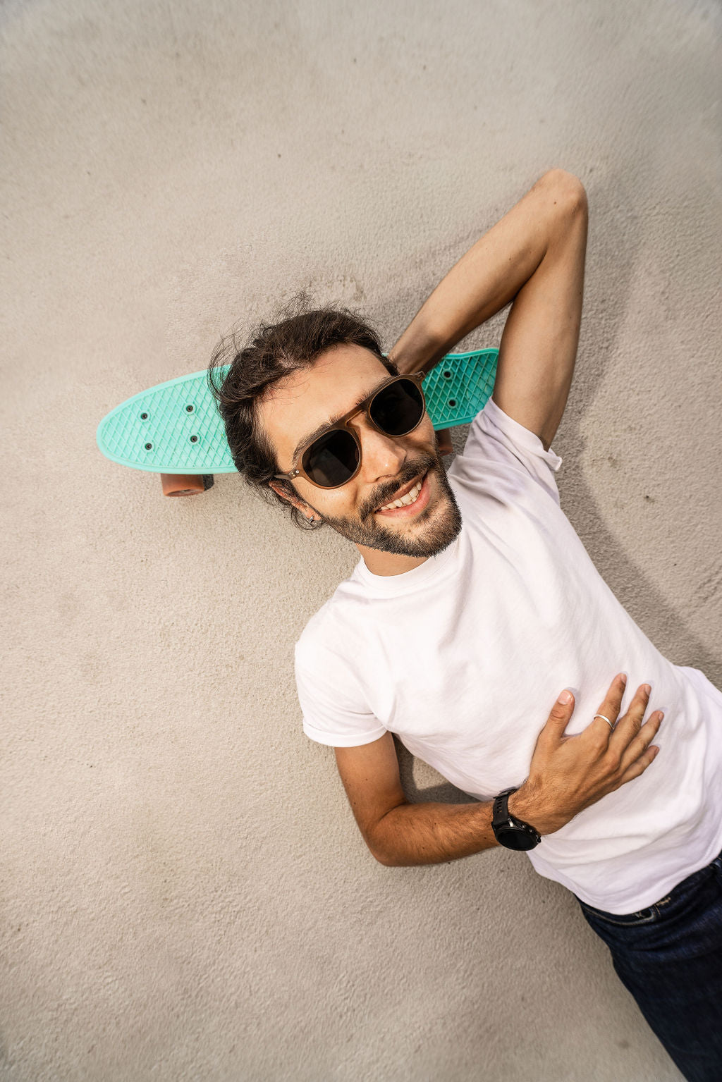 Man wearing champagne sunglasses with dark rounded lenses