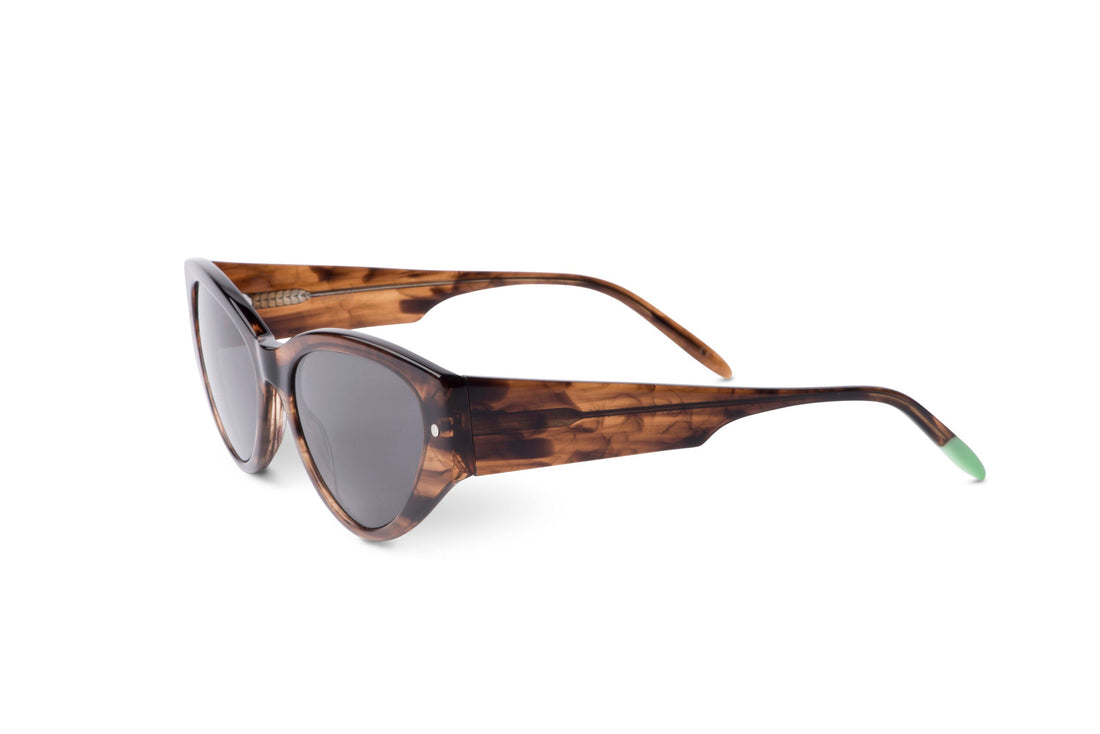Smokey brown tortoiseshell sunglasses side view with dark lenses and green tips