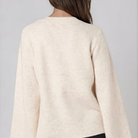 Beige knit cardigan back view with long wide sleeves and center seam