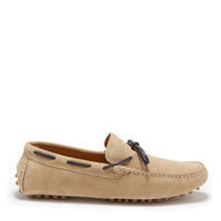 Taupe suede driving loafer with dark laces, stitched toe, and rubber heel-to-toe sole pegs