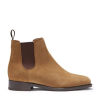 Tan suede Chelsea boot with dark elastic side panel, pull tab, and low heel.