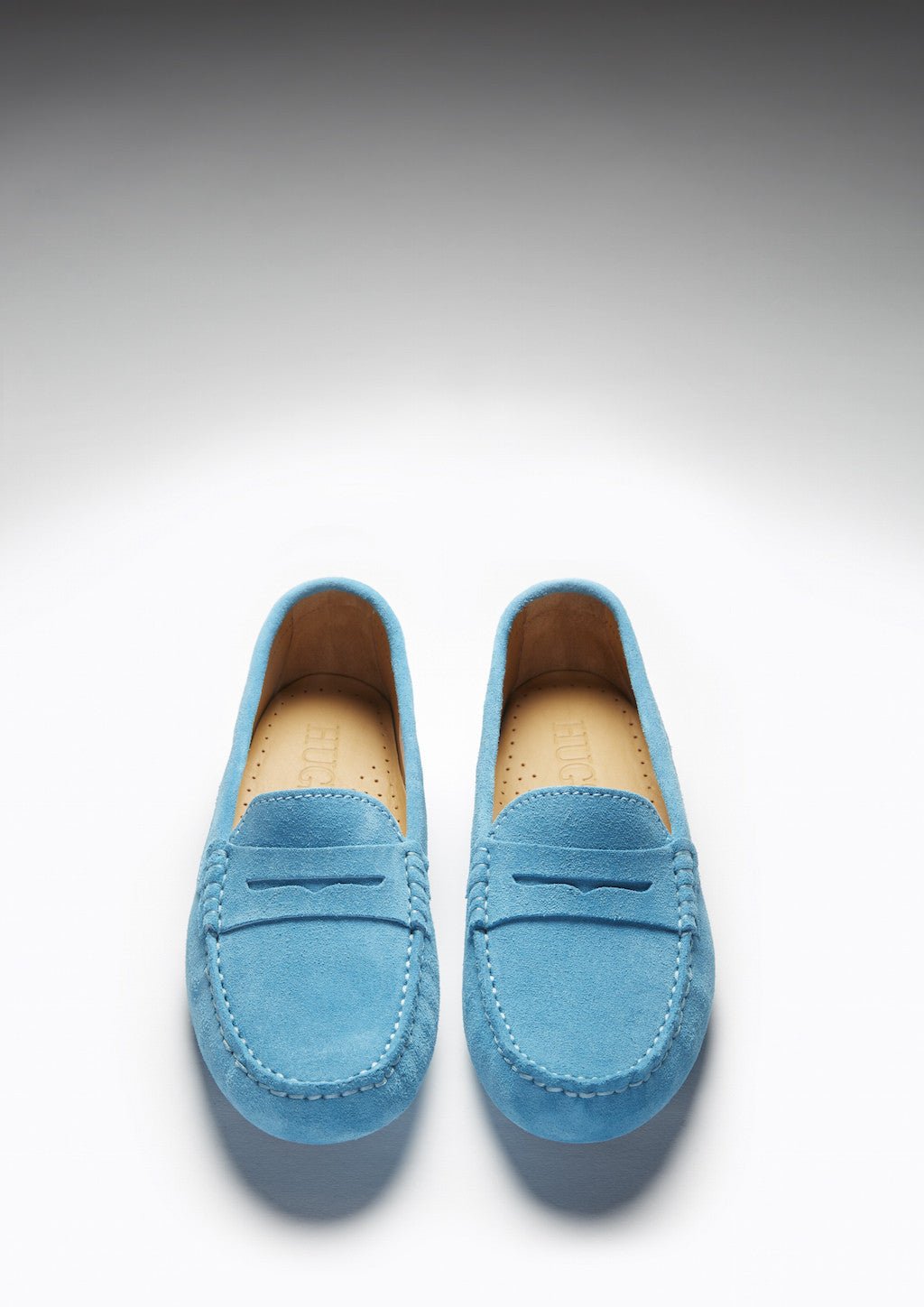 Pair of turquoise suede loafers viewed from above, showing penny straps and tan insoles