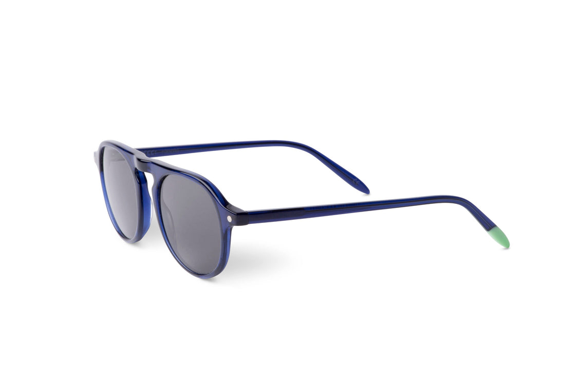 Indigo blue sunglasses, angled side view, dark lenses and green temple ends