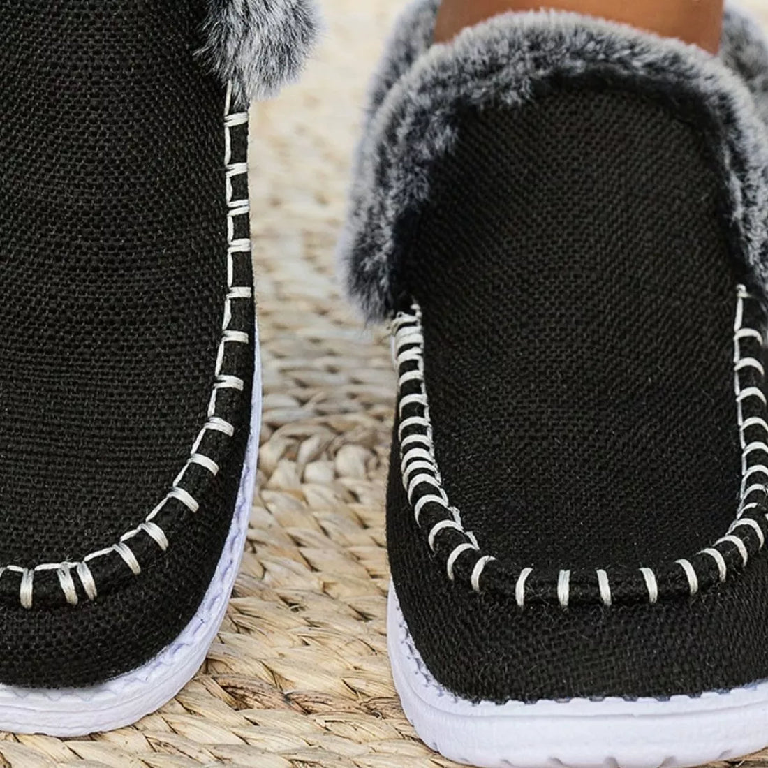 Black faux fur lined round toe slip-on shoes, close-up of interior and stitching