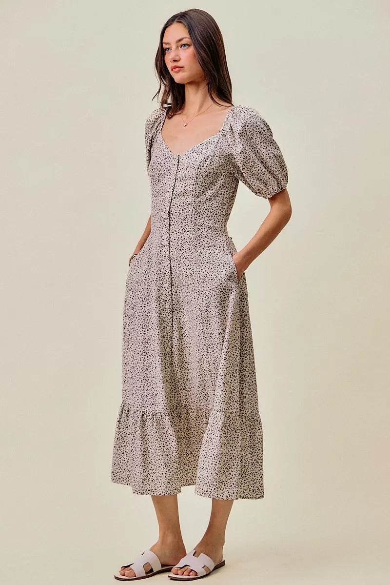 Ditsy floral midi dress side view, puff sleeves and gathered elastic waist with self belt
