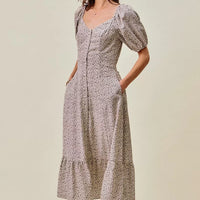 Ditsy floral midi dress side view, puff sleeves and gathered elastic waist with self belt