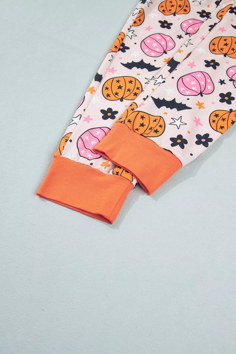 Pink pumpkin print pajama shorts with contrast orange hem