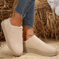Off-white plush lined ankle boots with round toe, cozy collar, slip-on design.