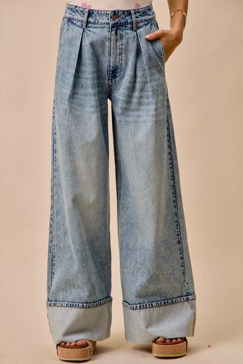 Light-wash mid-rise denim jeans with pleated front and wide straight legs, back view