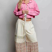 Candy pink cropped cotton jacket with eyelet texture, button front, and long sleeves