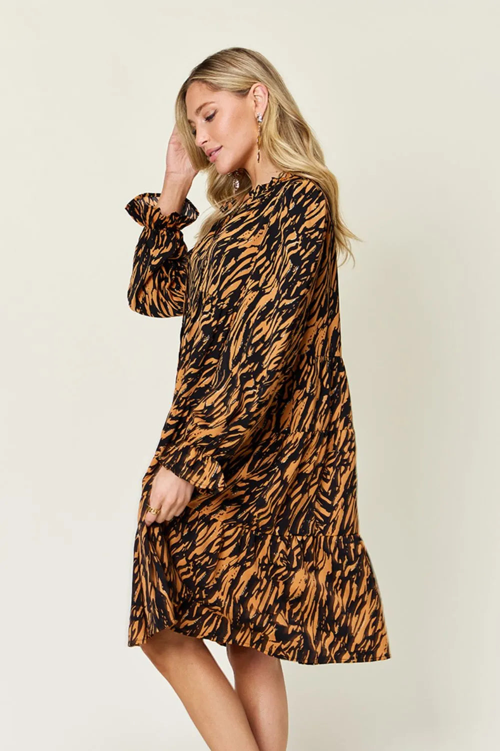 Caramel and black printed long-sleeve ruffle-tier midi dress, side view