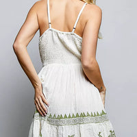 Natural palm tree print wrap dress back view with spaghetti straps and tiered ruffle hem