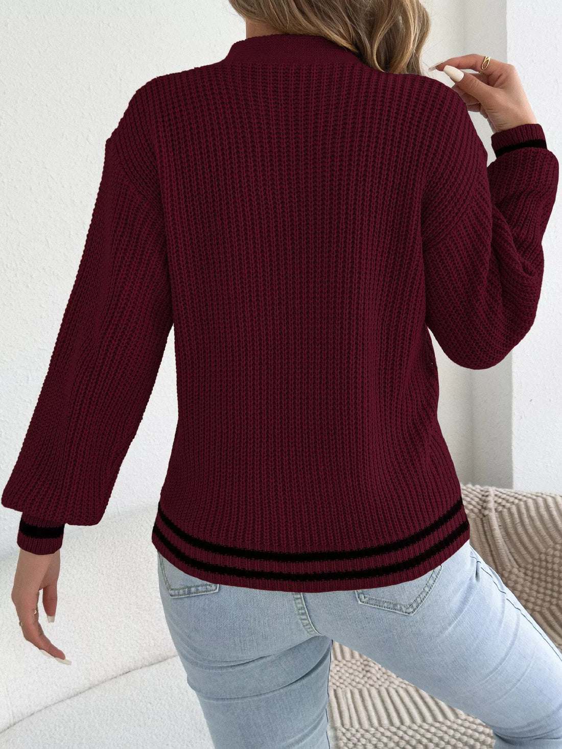 Burgundy cable knit sweater, back view with ribbed cuffs and hem