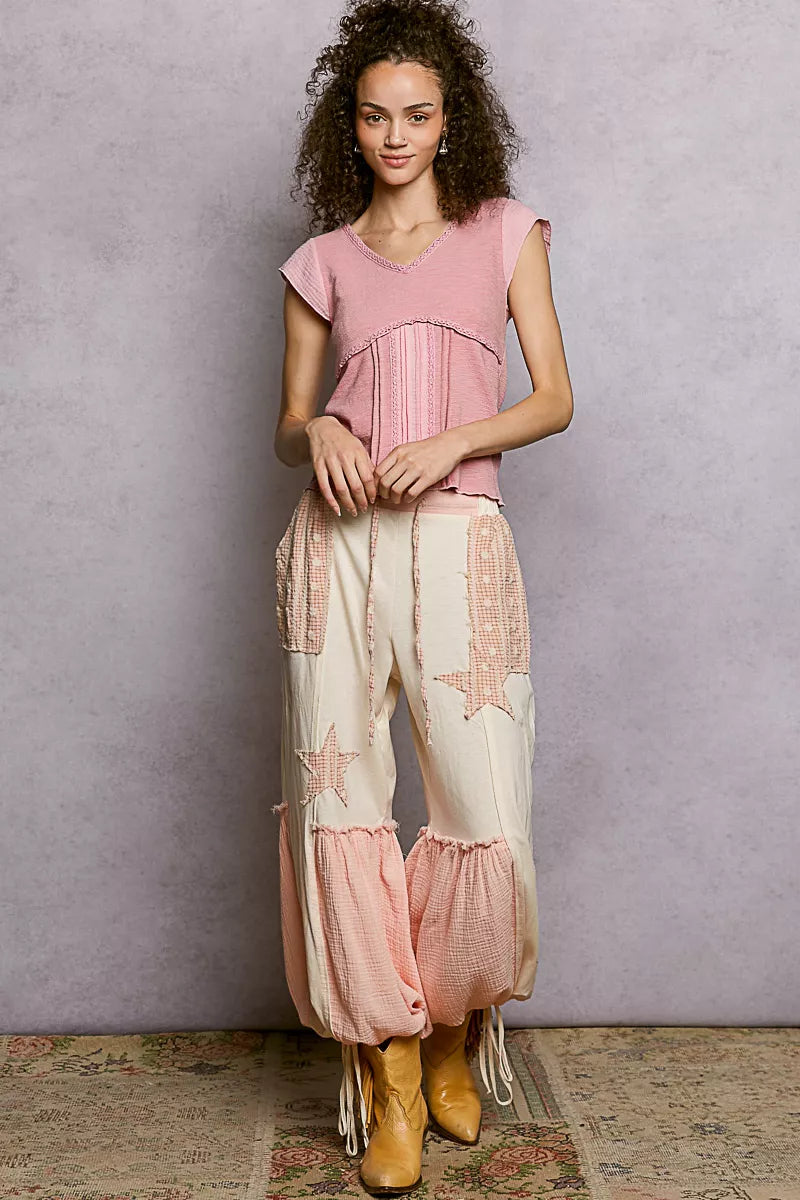 Soft pink V-neck knit top with lace-trim neckline and short sleeves, full-length view