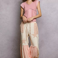 Soft pink V-neck knit top with lace-trim neckline and short sleeves, full-length view