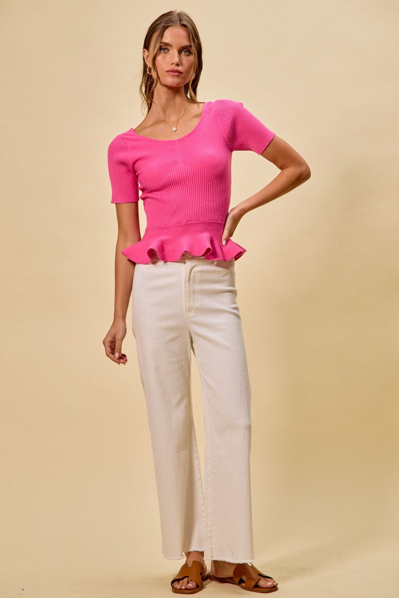 Hot pink ribbed knit peplum sweater top with short sleeves, front view on model