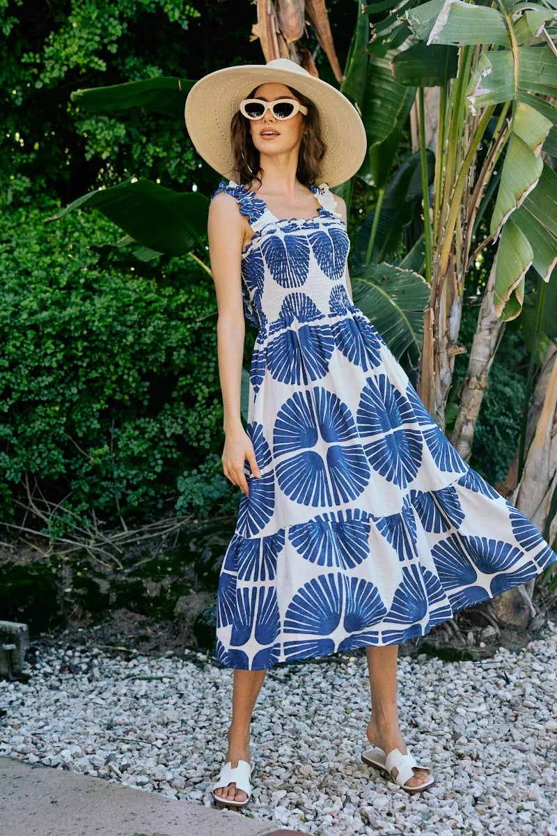 Sleeveless smocked bodice tiered midi dress with navy abstract print, lined interior