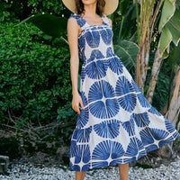 Sleeveless smocked bodice tiered midi dress with navy abstract print, lined interior