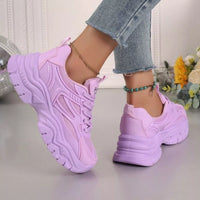Purple chunky platform sneakers with lace-up mesh upper and chunky outsole tread.