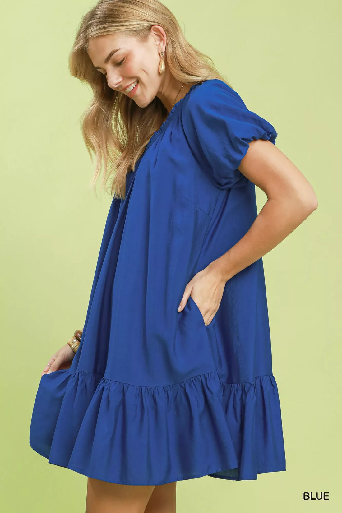 Blue shift mini dress with gathered waist and ruffle hem, side view.