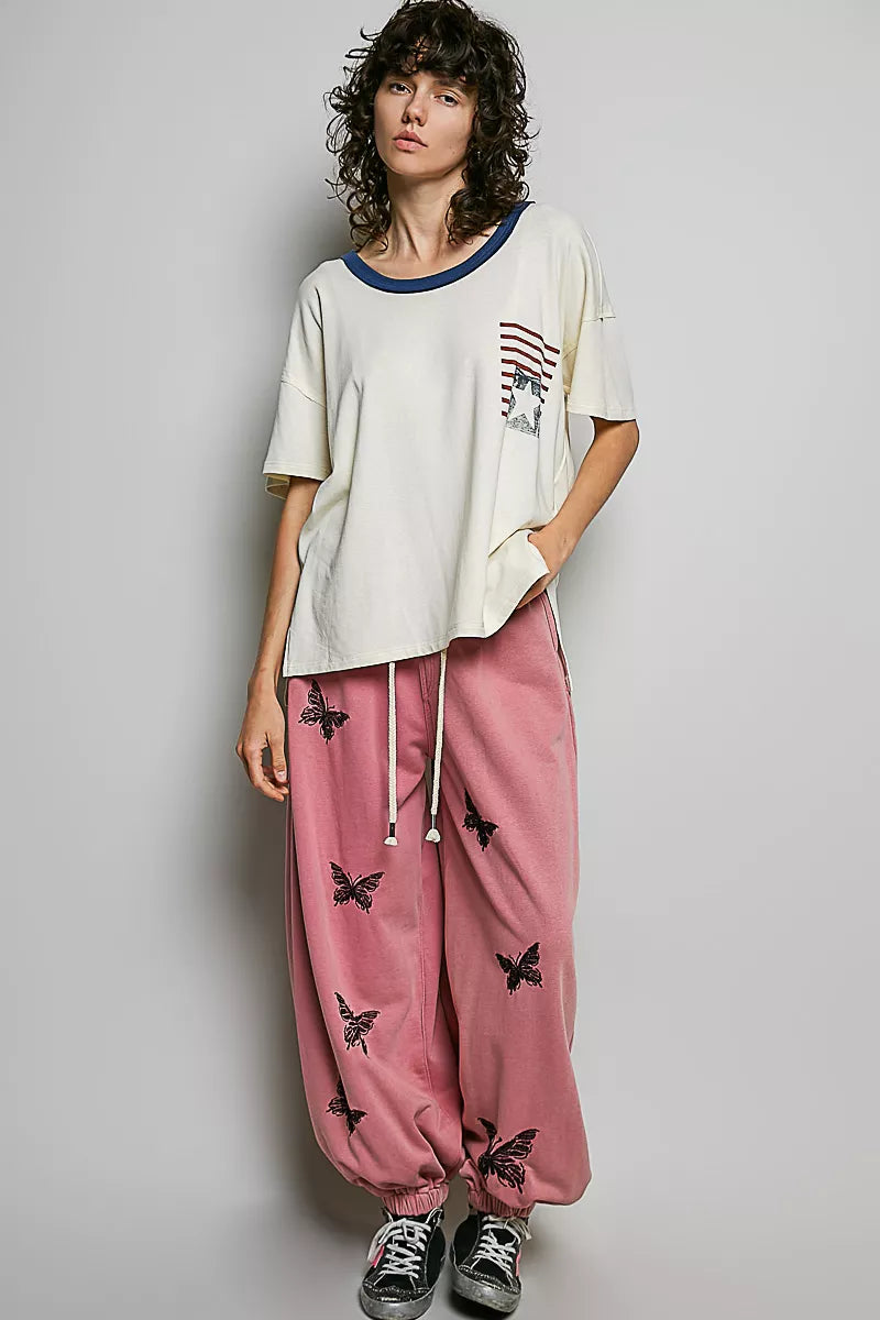 Cream cotton top with blue neckline trim and American flag graphic