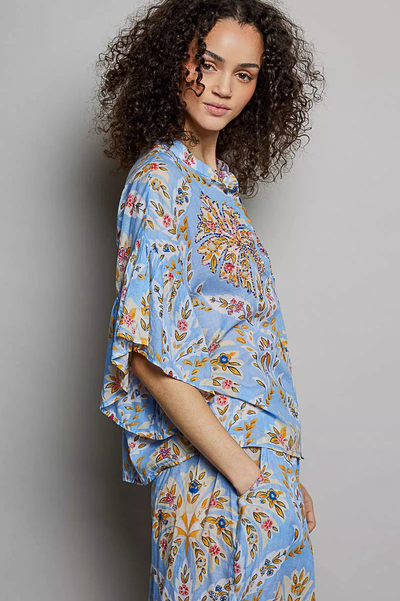 Blue floral printed woven ruffle-sleeve shirt with elastic waist, side view