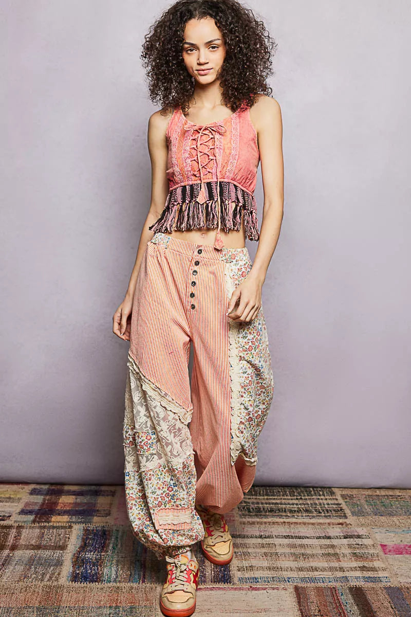 Pink lace-up tank top with lace detail and tassel fringe hem