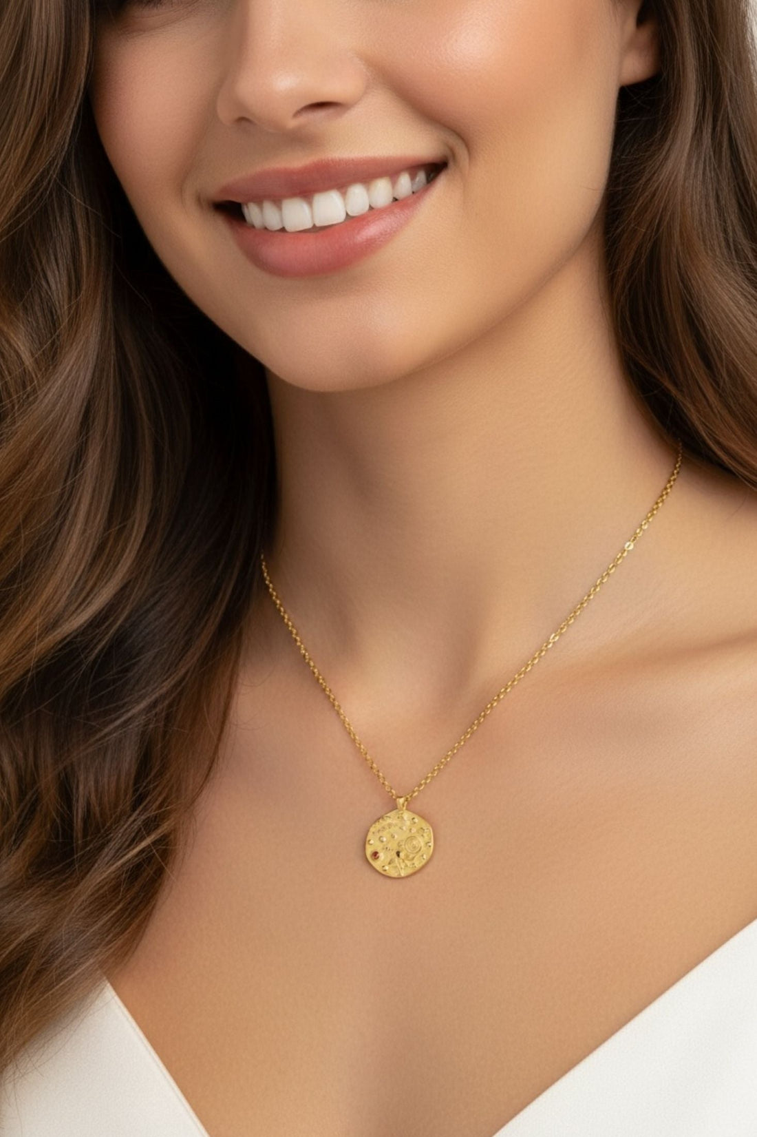 Gold-tone round pendant necklace worn by model, close-up
