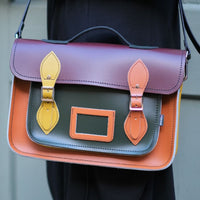 Handmade leather satchel with flap, plum top, orange and teal front panel, buckle straps