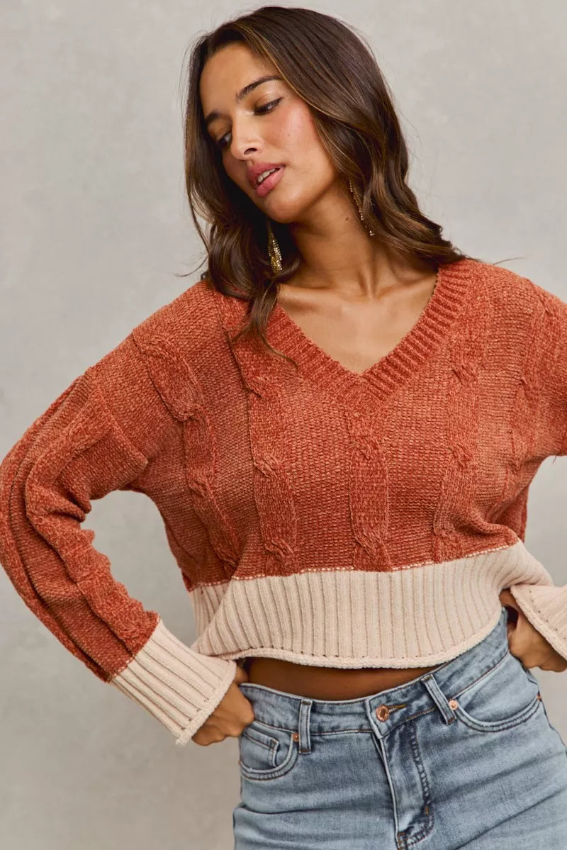 Rust V-neck chenille knit sweater with cream contrast waistband and ribbed cuffs