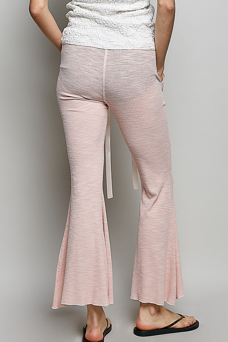 Blush pink textured knit drawstring pants with wide flared legs and inner ties