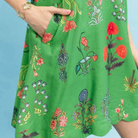Green floral mini dress fabric detail with colorful flowers and plants print