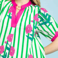 Green striped floral dress detail with pink neckline trim and cactus print