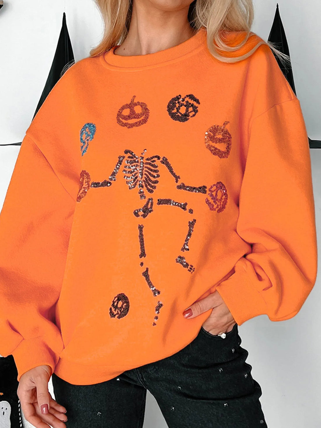 Orange sweatshirt with Halloween skeleton and pumpkin graphic, crewneck, long sleeves