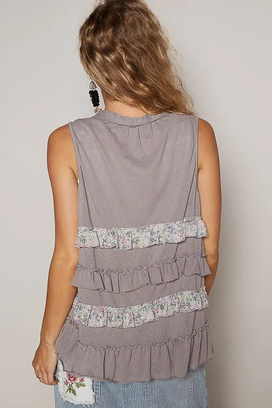 Grey sleeveless cardigan with tiered ruffles and floral hem trim